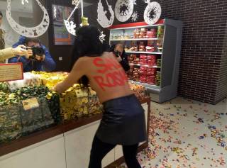 В Киеве активистка Femen ворвалась в магазин «Рошен», сметая с полок торты и разбрасывая конфеты